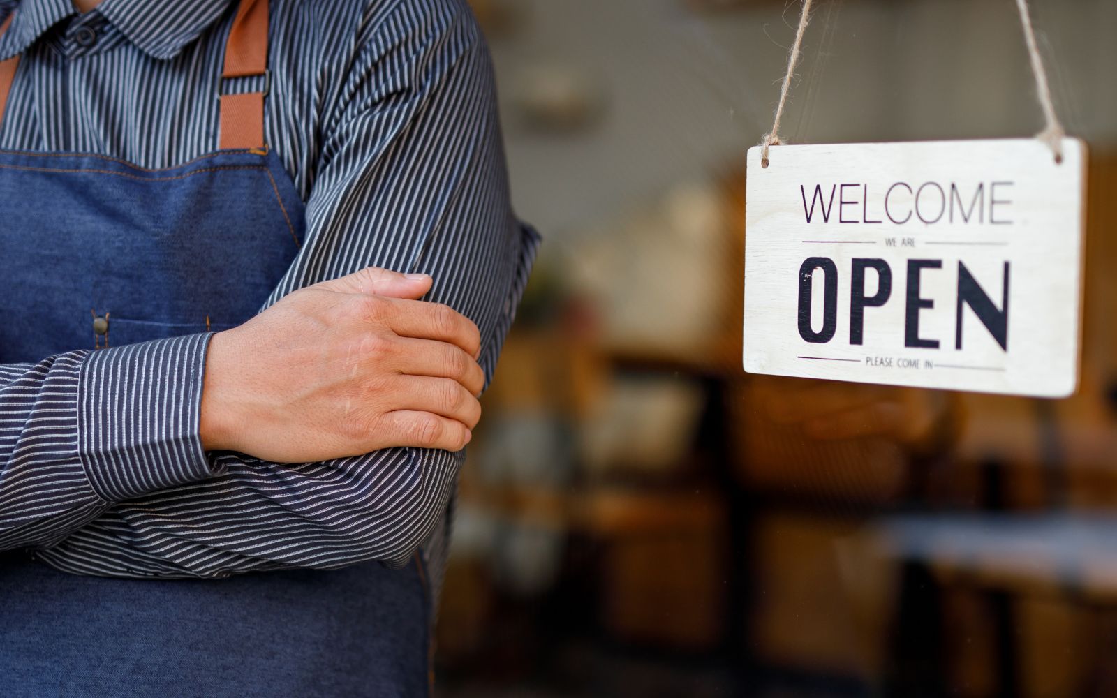 Business owner turning the open sign